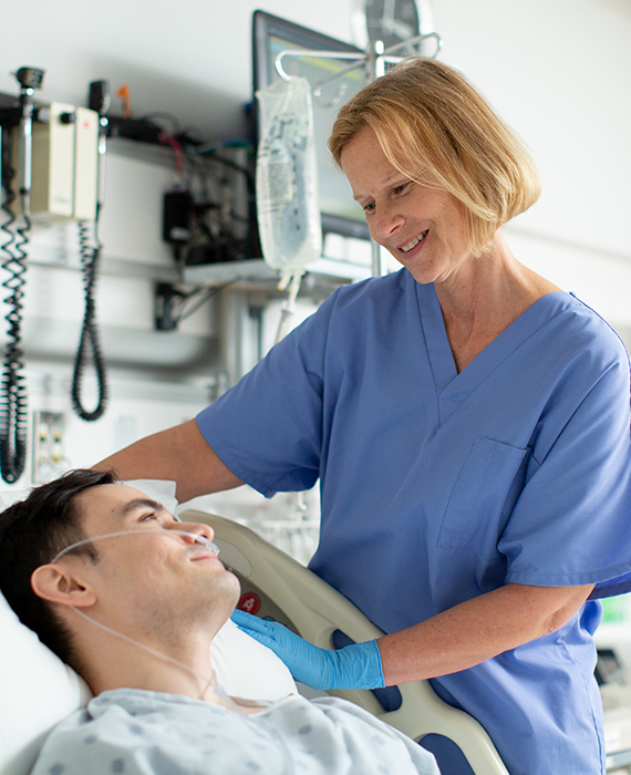 Nurse at bedside with patient