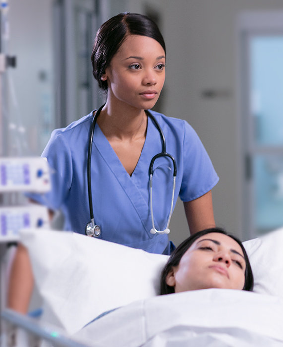 Nurse at a patients bedside