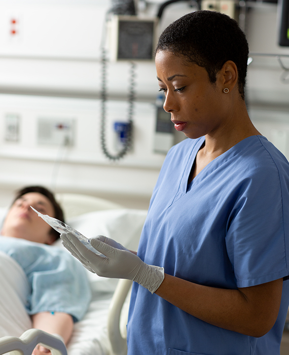 Nurse at a patients bedside