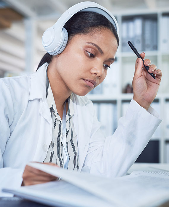 Woman reading and wearing headphones